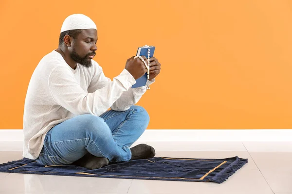 African-American Muslim man praying indoors