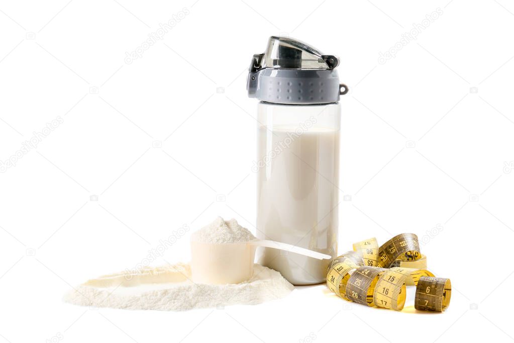 Bottle of protein shake with measuring tape on white background