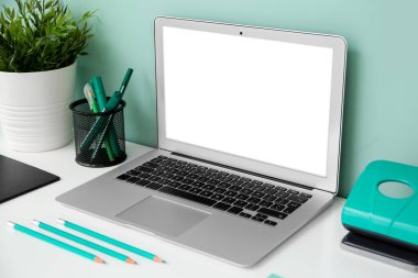 Renk duvarının yanında modern dizüstü bilgisayarı olan rahat bir iş yeri