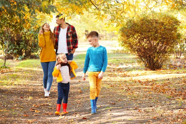 Happy family walking in autumn park — Stock Photo, Image
