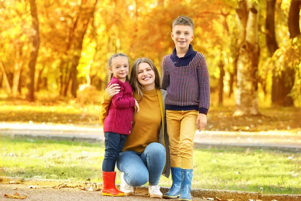 Happy family resting in autumn park — Stock Photo, Image