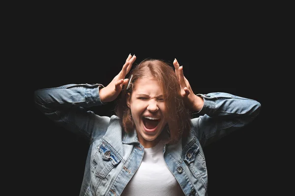 Screaming teenage girl on dark background — Stock Photo, Image