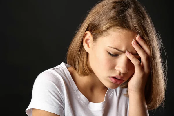 Sad teenage girl on dark background — Stock Photo, Image