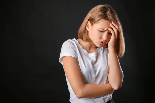 Trauriges Teenager-Mädchen auf dunklem Hintergrund — Stockfoto