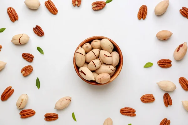 Bowl with tasty pecan nuts on white background — Stock Photo, Image