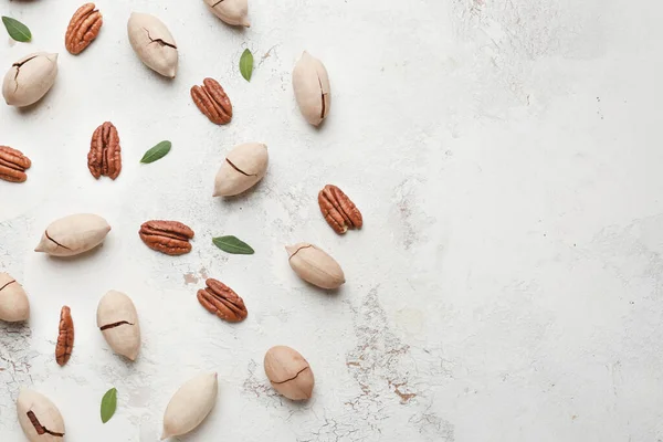 Tasty pecan nuts on light background — Stock Photo, Image