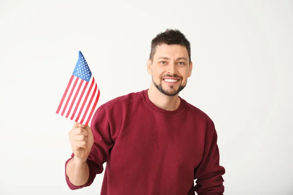 Handsome man with USA flag on light background. Memorial Day celebration — Stock Photo, Image