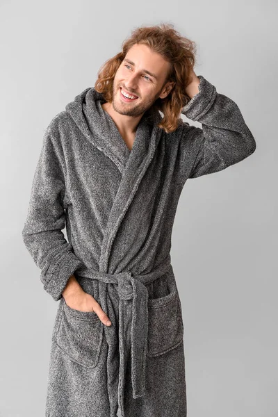 Portrait of handsome man in bathrobe on grey background — Stock Photo, Image