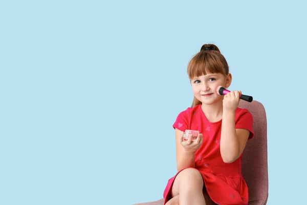 Linda niña con cosméticos en el fondo de color —  Fotos de Stock