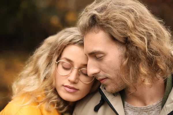 Young couple in park on autumn day