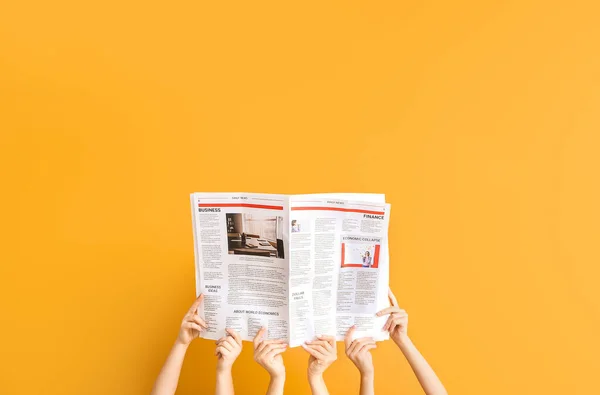 Female hands with newspapers on color background — Stock Photo, Image