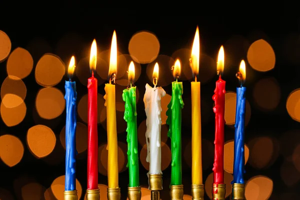 Menorah with burning candles for Hanukkah on dark background with defocused lights — Stock Photo, Image