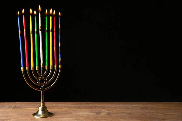 Menorah with candles for Hanukkah on table against dark background — Stock Photo, Image