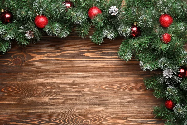 Composition with beautiful Christmas tree branches on wooden background — Stock Photo, Image