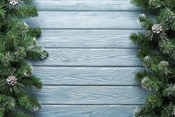Beautiful fir branches on wooden background — Stock Photo, Image