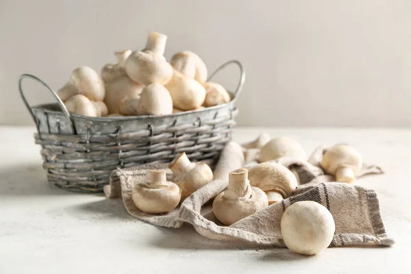 Basket with fresh mushrooms on table Stock Picture