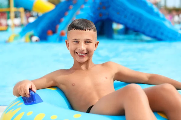 Boy with swimming ring in aqua park