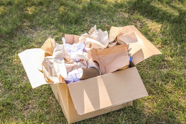 Box with gathered garbage outdoors. Concept of recycling — Stock Photo, Image