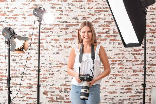 Beautiful female photographer in studio — Stock Photo, Image