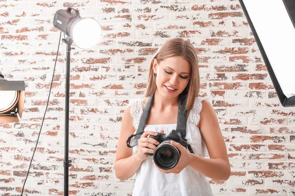 Beautiful female photographer in studio — Stock Photo, Image