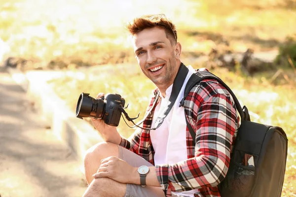 Handsome male photographer with camera outdoors — Stock Photo, Image