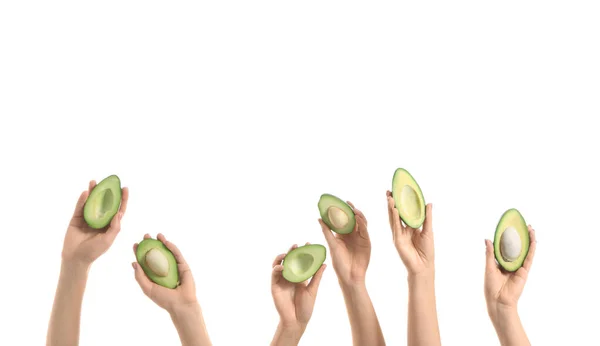 Kvinnliga händer med färska avokado på vit bakgrund — Stockfoto