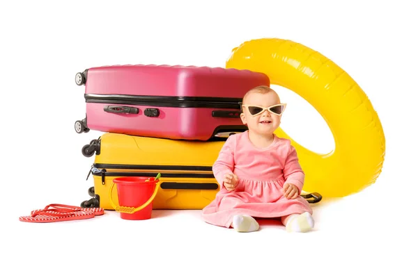 Cute baby with suitcases and inflatable ring on white background — Stock Photo, Image