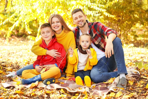 Happy family resting in autumn park — Stock Photo, Image