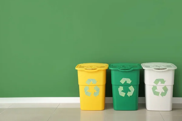 Containers for garbage near color wall. Recycling concept