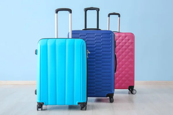 Packed suitcases near color wall. Travel concept — Stock Photo, Image