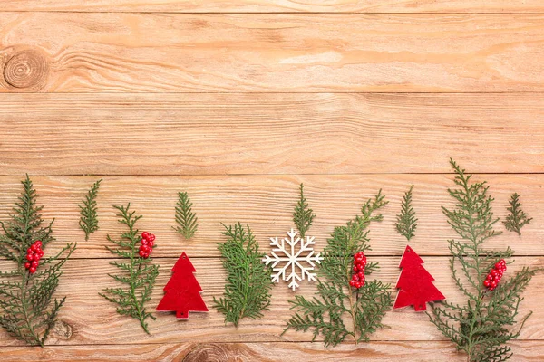 Christmas tree branches with decor on wooden background — Stock Photo, Image