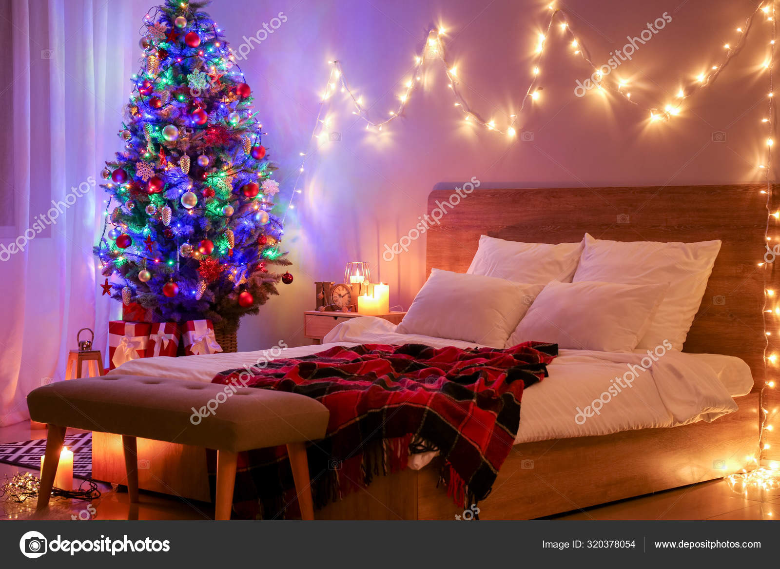 Interior of bedroom with beautiful decorated Christmas tree at