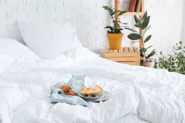 Tray with tasty breakfast on bed — Stock Photo, Image