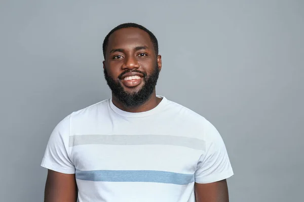 Handsome African-American man on grey background — Stock Photo, Image