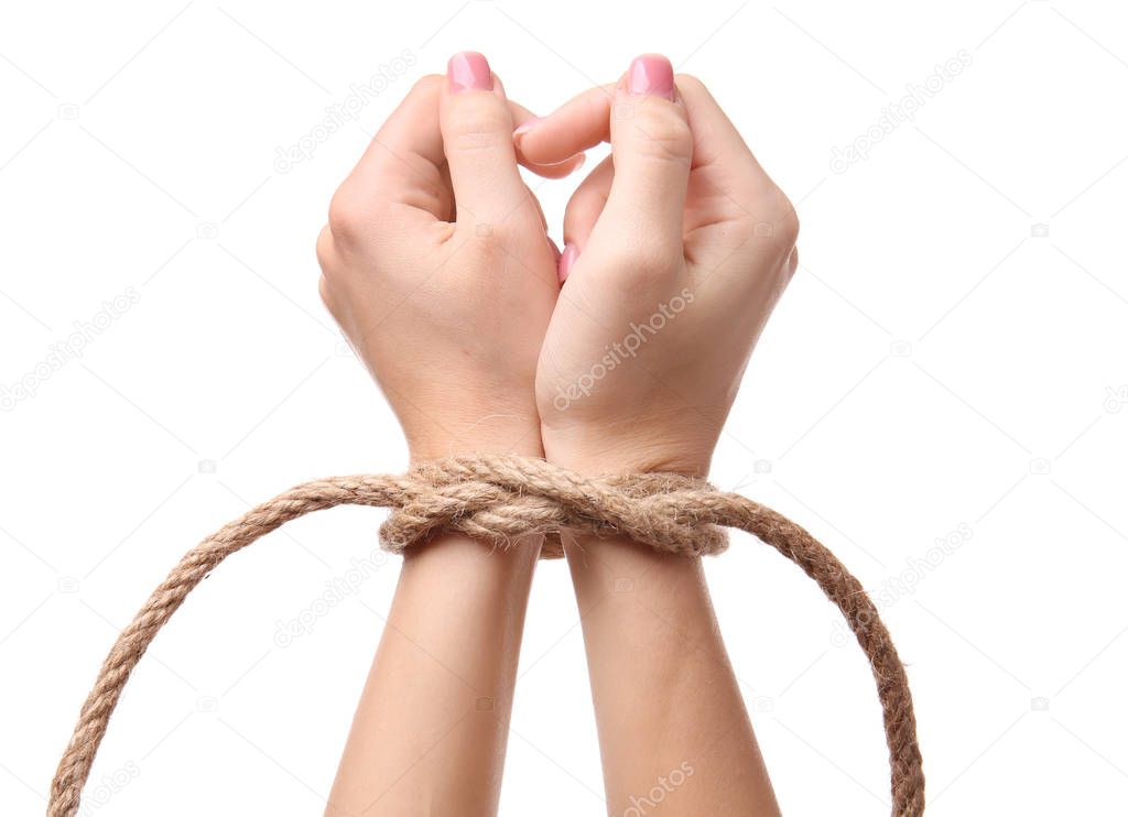 Female hands tied with rope on white background