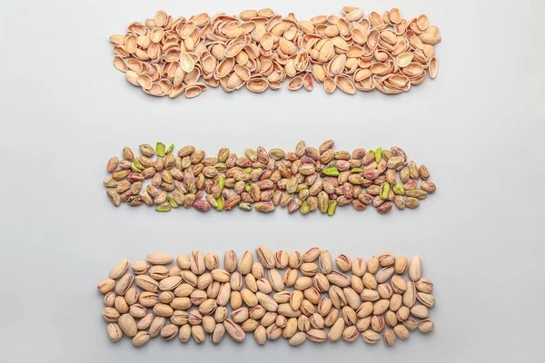 Tasty pistachio nuts on light background — Stock Photo, Image