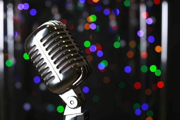 Retro microphone on stage against defocused lights — Stock Photo, Image
