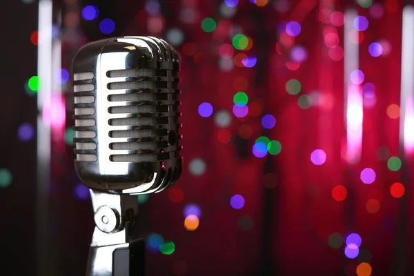 Retro microphone on stage against defocused lights — Stock Photo, Image