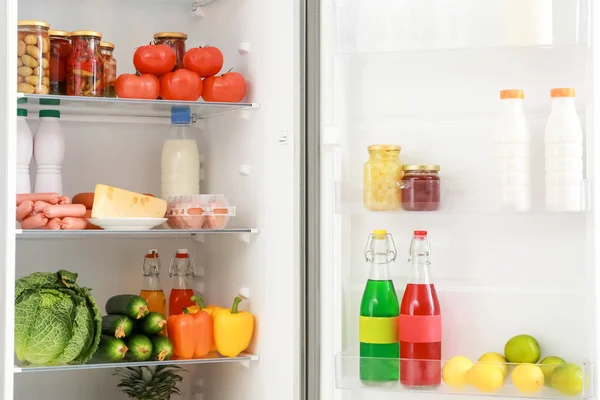 Different products on shelves in fridge — Stock Photo, Image