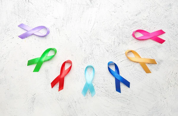Different awareness ribbons on light background