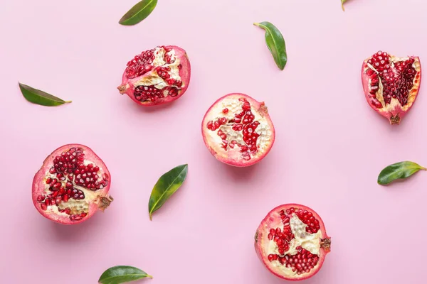 Ripe juicy pomegranates on color background — Stock Photo, Image