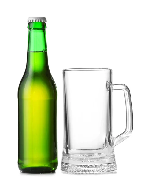 Bottle of fresh beer and empty mug on white background — Stock Photo, Image
