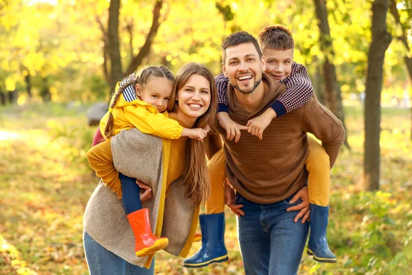 Happy family resting in autumn park — Stock Photo, Image