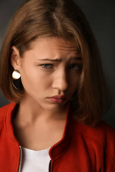 Sad teenage girl on dark background — Stock Photo, Image