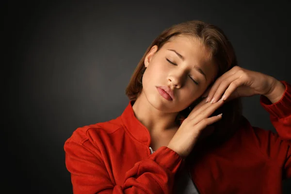 Cute teenage girl on dark background — Stock Photo, Image