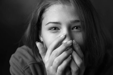 Siyah-beyaz, arka planda üzgün genç kız portresi, yakın plan.