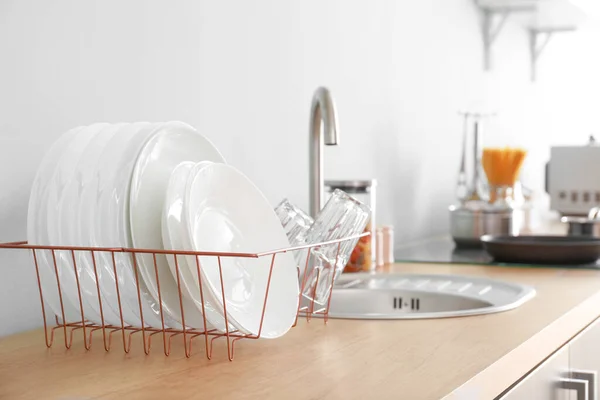 Set of clean dishware near kitchen sink — Stock Photo, Image