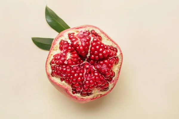 Ripe juicy pomegranate on light background — Stock Photo, Image