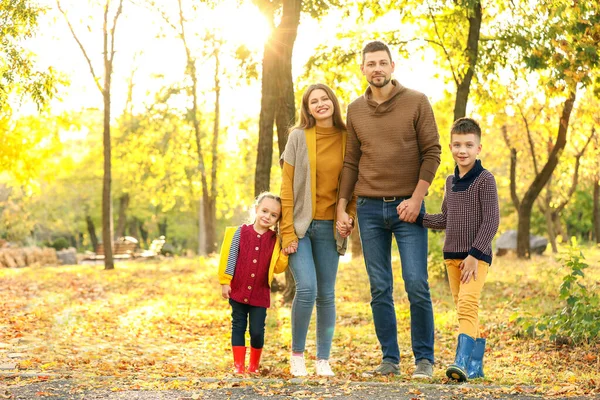 Happy family resting in autumn park — Stock Photo, Image