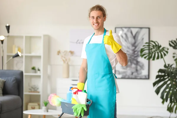 Male janitor with cleaning supplies in flat — Stock Photo, Image